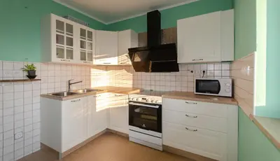 a kitchen with white cabinets and a sink at Deerwood-Large Villa relax with castle view in Bled