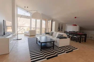 a living room with a white couch and a table at Bright loft near Bohinj lake in Bohinj