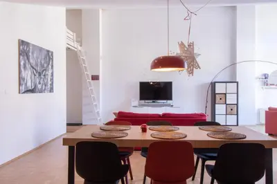 a living room with a table and chairs at Bright loft near Bohinj lake in Bohinj