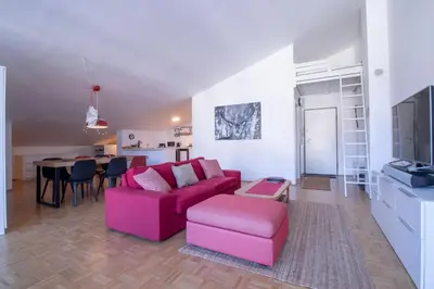 a living room with a pink couch and a table at Bright loft near Bohinj lake in Bohinj