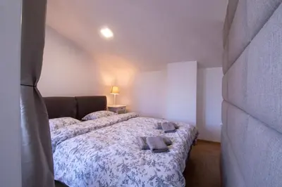 a bedroom with two beds with towels on them at Bright loft near Bohinj lake in Bohinj