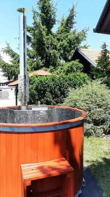 an outdoor fountain with a bench in a yard at Vila Idila in Lendava