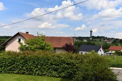 a house with a red roof and some bushes at Vila Idila in Lendava