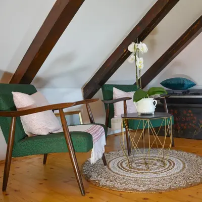 a living room with two chairs and a table at Vinum Vidae in Lendava