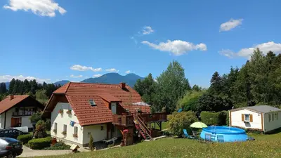 a house with a roof in a yard at Holiday home Rozika in Slovenj Gradec