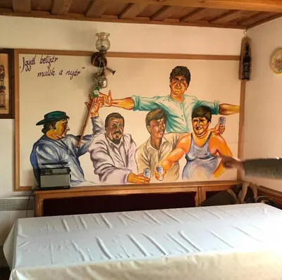 a bedroom with a painting on the wall at Pri konjskem pajdašu in Lendava
