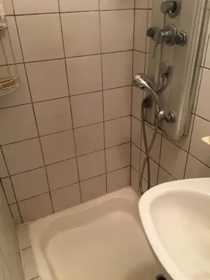 a bathroom with a tub and a sink at Pri konjskem pajdašu in Lendava