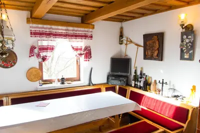 a room with a bench and a tv and a window at Pri konjskem pajdašu in Lendava