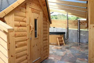 a woodenshed with a wooden door in a house at Vila Tamaškut in Lendava