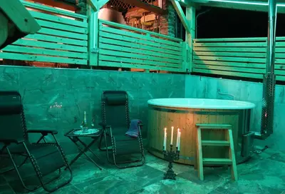 a room with two chairs and a table with candles at Vila Tamaškut in Lendava