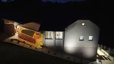 a house at night with the lights on at Vila Tamaškut in Lendava