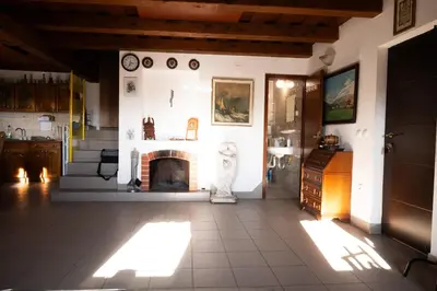 a living room with a fireplace and a table at Zidanica Balantič in Dobrovnik