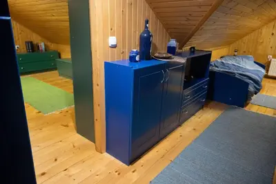 a room with a blue cabinet and a bed at Zidanica Balantič in Dobrovnik