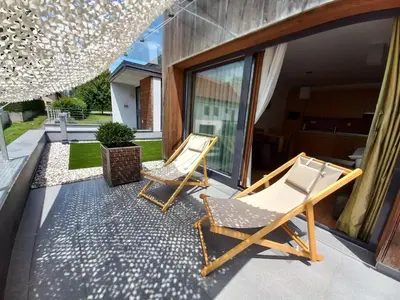 two chairs and a table on a patio at Apartments Maleric with Indoor Pool and Wellness in Dragatuš