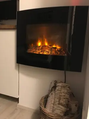 a fireplace in a living room with a fire in it at Apartment Loyd, Kranjska Gora - studio in Kranjska Gora
