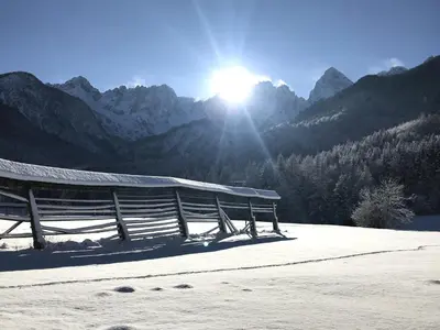 a group of benches in front of a mountain at Apartment Loyd, Kranjska Gora - studio in Kranjska Gora