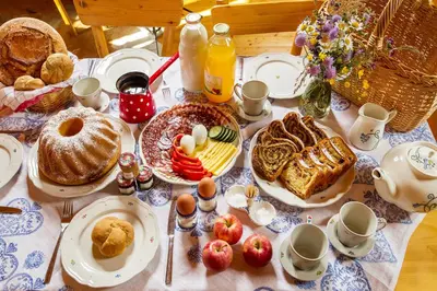 a table with breakfast foods and eggs on it at Farm Stay Pirc in Laško