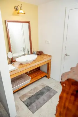 a bathroom with a sink and a mirror at Hiška pod Krasom in Renče