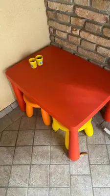 a red table with two cups on top of it at Hiška pod Krasom in Renče