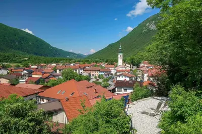 a view of a town with mountains in the background at Hostel Kobarid in Kobarid