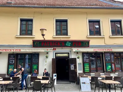 a restaurant with tables and chairs in front of it at Patrick's Pub in Maribor