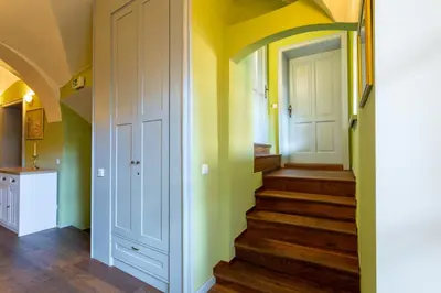 a hallway with stairs in a home with yellow walls at Patrick's Pub in Maribor