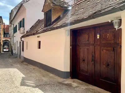 a building with wooden doors on the side of a street at Patrick's Pub in Maribor