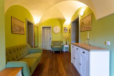 a living room with a couch and a clock on the wall at Patrick's Pub in Maribor