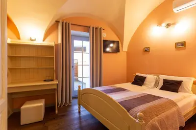 a bedroom with a bed and a book shelf at Patrick's Pub in Maribor