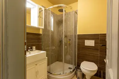 a bathroom with a shower and a toilet and a sink at Patrick's Pub in Maribor
