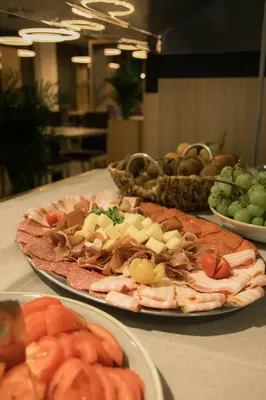 a table with plates of food on a table at Hotel Aqua Roma in Rimske Toplice