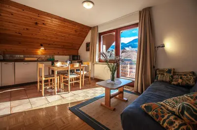 a living room with a couch and a table at Guest House Alenka in Bohinj