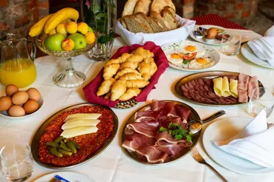 a table with many plates of food on it at Bed and Breakfast Portal in Ljubljana