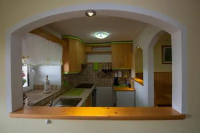 a kitchen with an archway in the middle of it at Apartma Vidmar Otlica in Ajdovščina