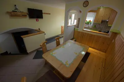 a living room with a table and a fireplace at Apartma Vidmar Otlica in Ajdovščina