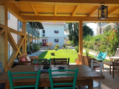 a patio with a wooden table and chairs at Accommodation Baron in Ljubljana