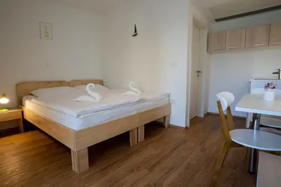 a bedroom with a bed with swans on it at Accommodation Baron in Ljubljana