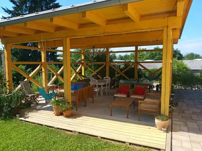 a wooden gazebo with a table and chairs at Accommodation Baron in Ljubljana