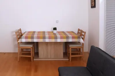 a table with a table cloth on it with two chairs at Apartma Dolinar in Gorenja Vas