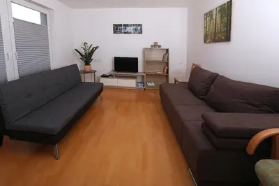 a living room with a couch and a television at Apartma Dolinar in Gorenja Vas