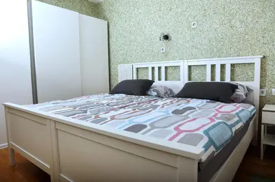 a bedroom with a large white bed in a room at Apartma Dolinar in Gorenja Vas