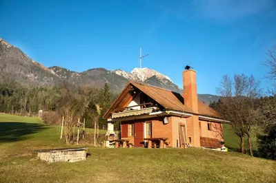 a house on a hill with mountains in the background at Little dream house in a perfect spot in Zalog