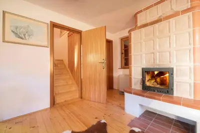 a living room with a fireplace and a dog laying on the floor at Little dream house in a perfect spot in Zalog