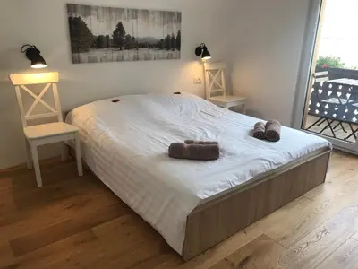a large bed with two pairs of shoes on it at LAKE HOUSE BOHINJ in Bohinj