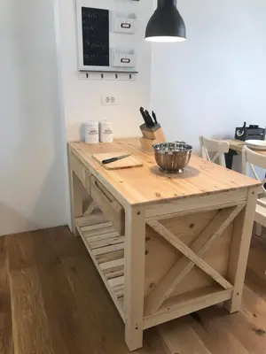 a wooden island in a kitchen with a table at LAKE HOUSE BOHINJ in Bohinj