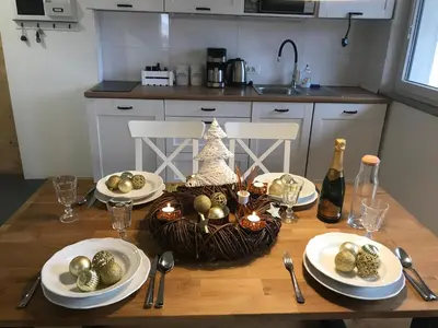 a table with plates and a basket of christmas decorations at LAKE HOUSE BOHINJ in Bohinj