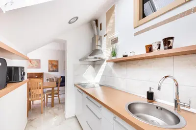 a kitchen with a sink and a counter top at Apartments Julian Adventure in Kranjska Gora