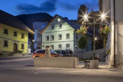 an orange car parked in front of a white building at Apartments Julian Adventure in Kranjska Gora