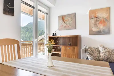 a dining room with a table and a window at Apartments Julian Adventure in Kranjska Gora