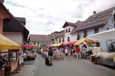 a crowd of people walking down a street in a market at Apartments Julian Adventure in Kranjska Gora